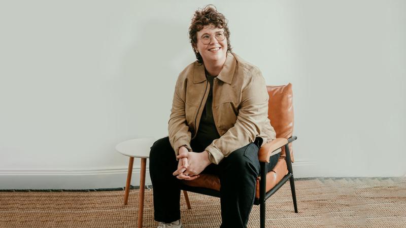 emer maguire sat on an orange chair