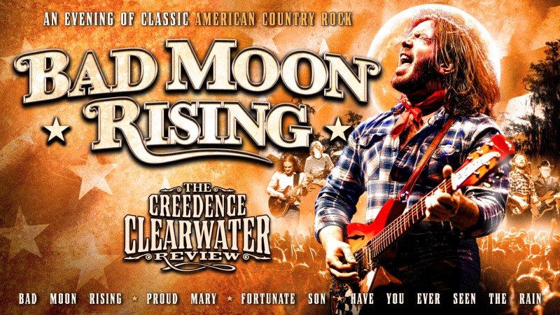 A man with a guitar in a checked shirt singing against a backdrop of a show at night with a large moon. Next to him is the logo of Bad Moon Rising.
