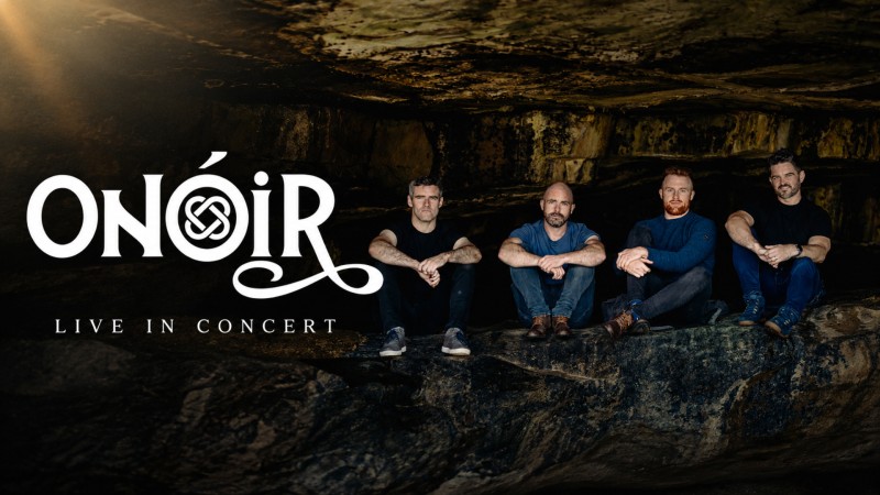 Onoir sitting on the floor in a line in a cave facing the camera. Their logo is superimposed to the left.
