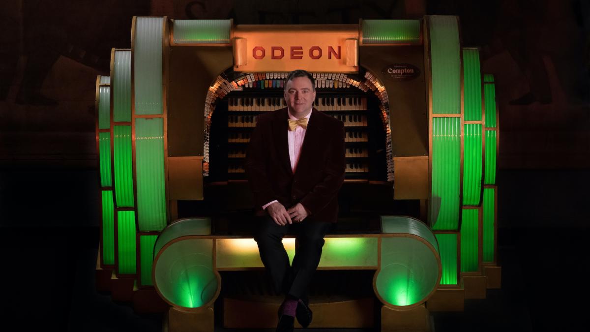 Donald MacKenzie by green lit Odeon organ