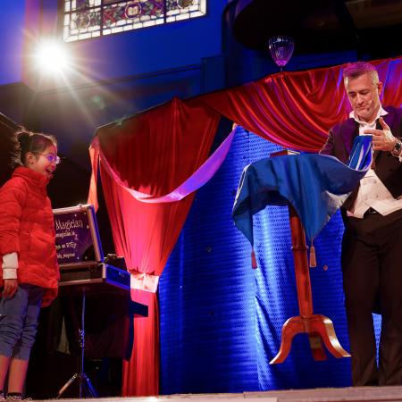 Joe the magician makes a table fly! With child Christy (permission granted)