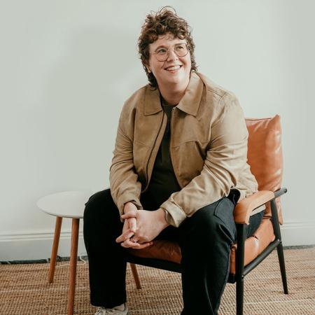 Emer Maguire sitting on an orange chair